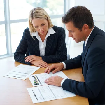 Fitness business owner reviewing equipment financing documents