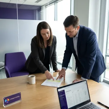 Compliance consultants reviewing regulatory documents in an office