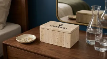 Nightstand surface styled with lidded box ceramic dish and glass carafe arrangement