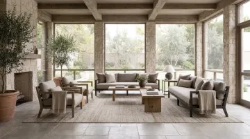 Belgian farmhouse screened porch with limestone floors and natural fiber furnishings