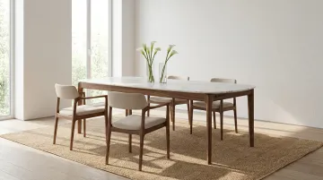 Minimalist dining space with slim marble table warm wood frame and linen chairs