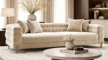 Velvet sectional sofa with brass metal accents in richly styled living room
