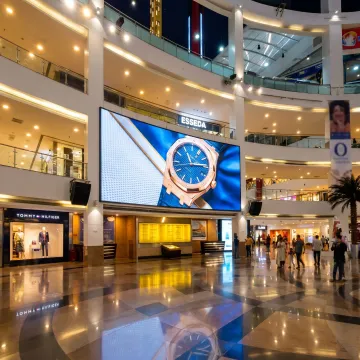 Digital advertising screen near mall storefronts