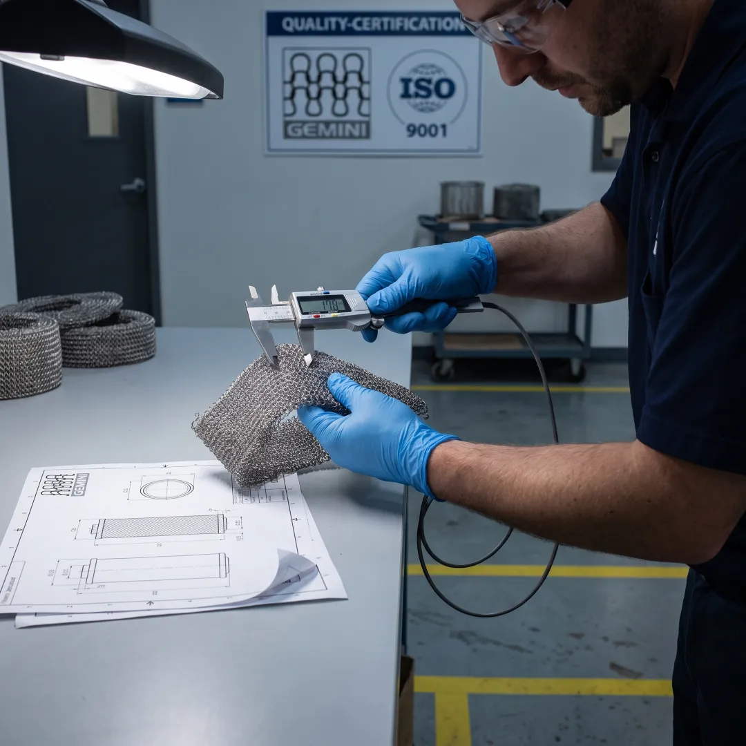 Technician inspecting compressed wire mesh gasket