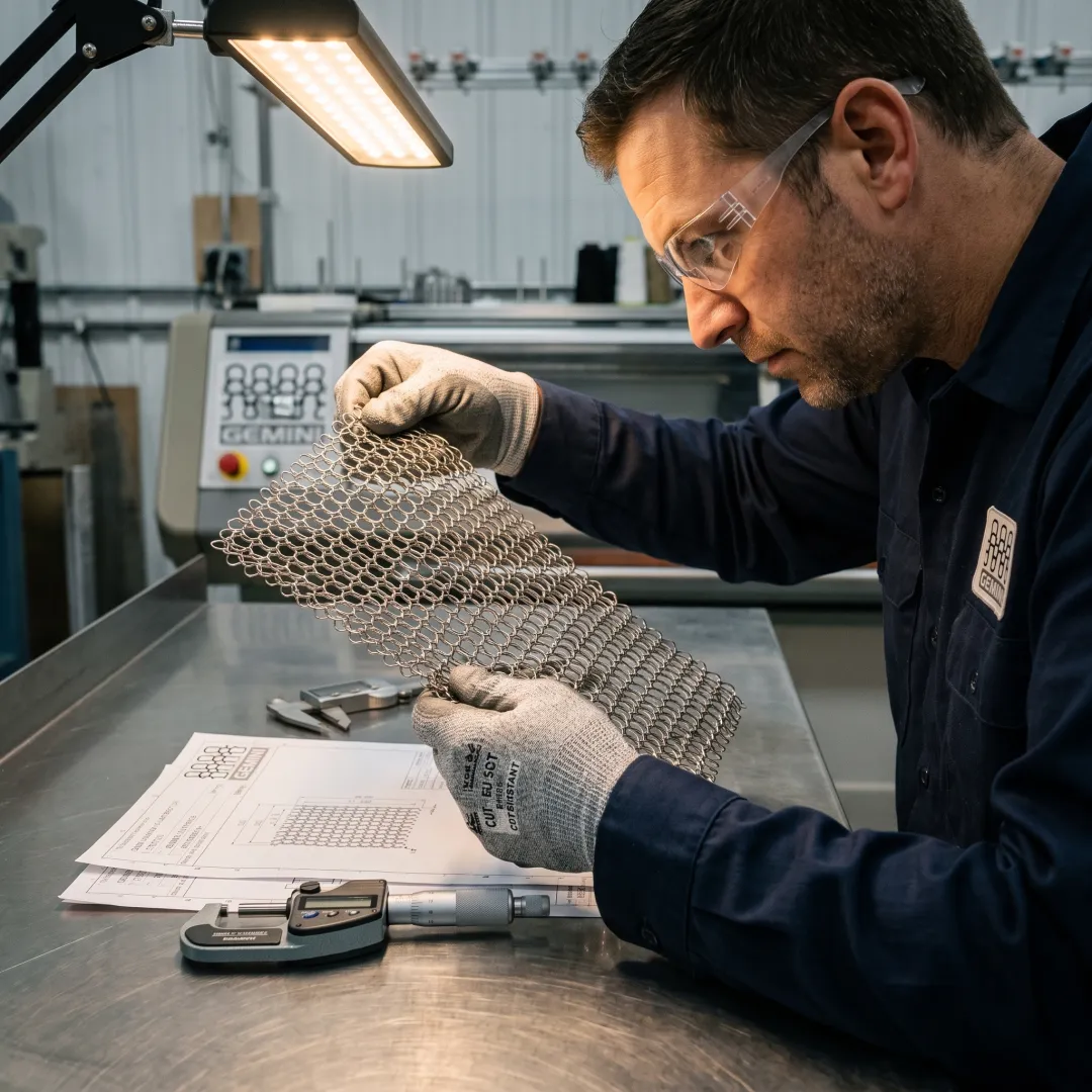 Technician inspecting stainless steel mesh