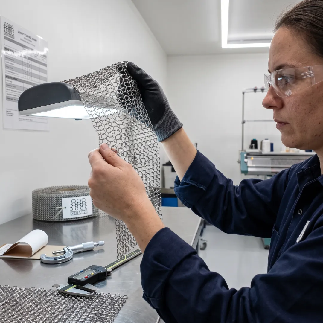 Industrial technician inspecting knitted wire mesh