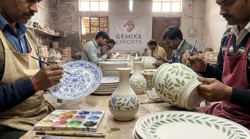 Artisans hand-decorating ceramic dinnerware at Khurja factory workbench