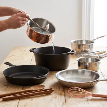 Handcrafted cookware on a kitchen worktable