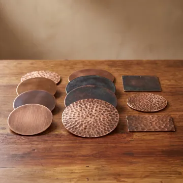 Custom copper patina samples on a workbench