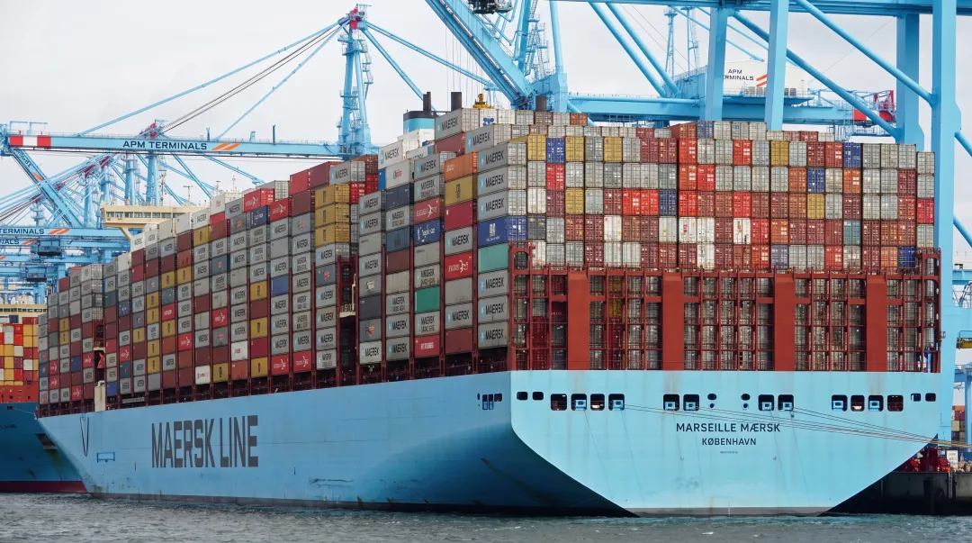 Standardized shipping containers stacked on ocean freight vessel deck during international transit