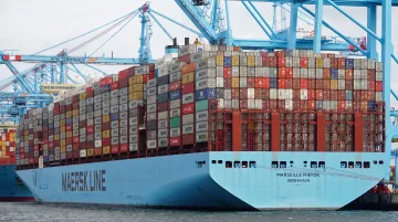 Standardized shipping containers stacked on ocean freight vessel deck during international transit
