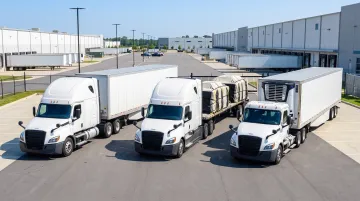 Modern trucking fleet with dry van refrigerated and flatbed trailers at logistics terminal
