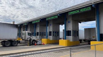 Laredo border crossing with commercial trucks waiting for customs inspection and clearance