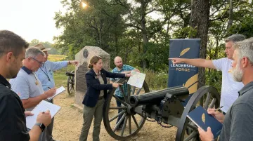Corporate leaders training on historic Gettysburg battlefield with facilitator