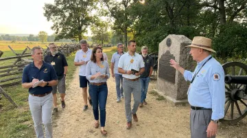 Leadership team walking historic battlefield during immersive trust-building program