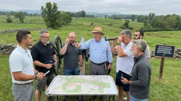 Executive team engaged in Gettysburg battlefield leadership simulation exercise
