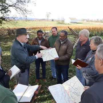 Facilitator leading a leadership discussion outdoors