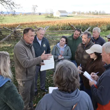 Facilitator leading a corporate team discussion outdoors