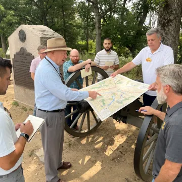 Facilitator coaching executives during a leadership exercise