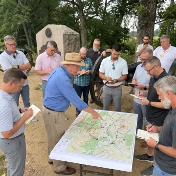 Facilitator guiding leaders through a strategic group exercise