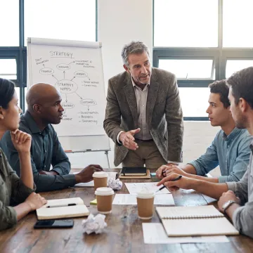 Facilitator guiding a leadership negotiation exercise