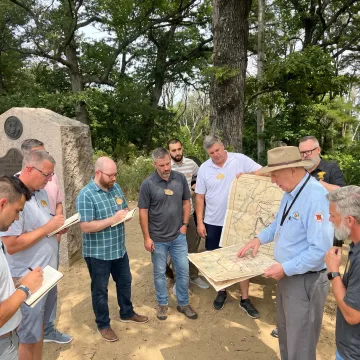 Facilitator coaching emerging leaders outdoors