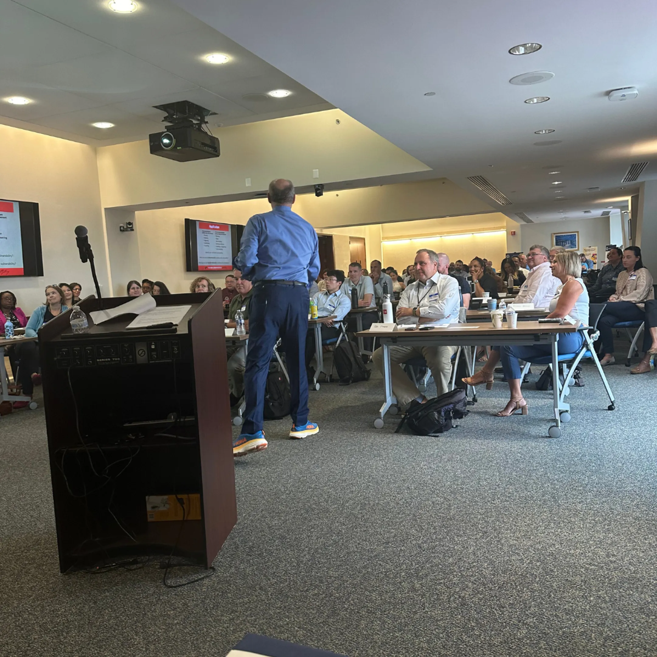 Facilitator guiding corporate leaders through an experiential leadership exercise