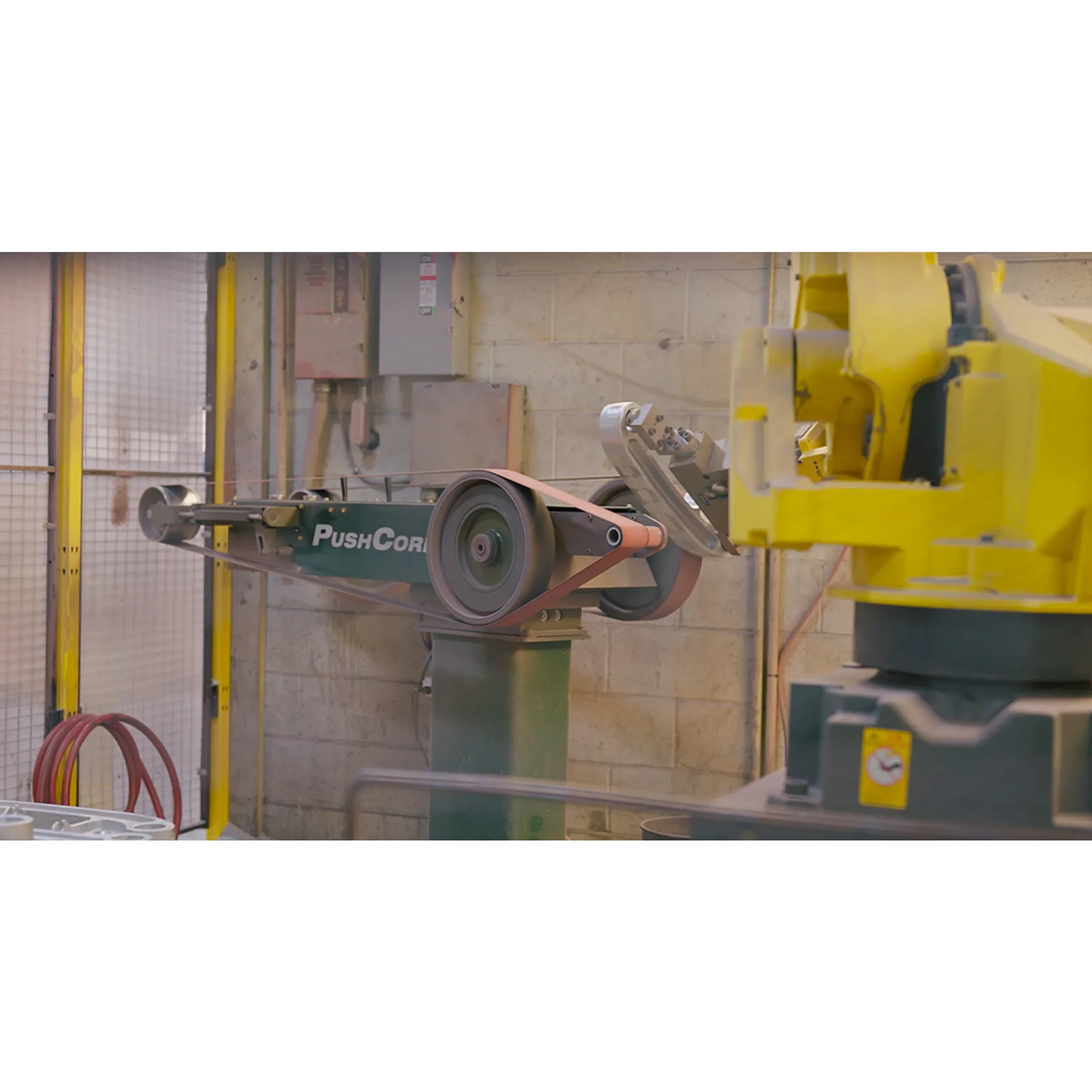 Engineer reviewing a robotic sanding cell