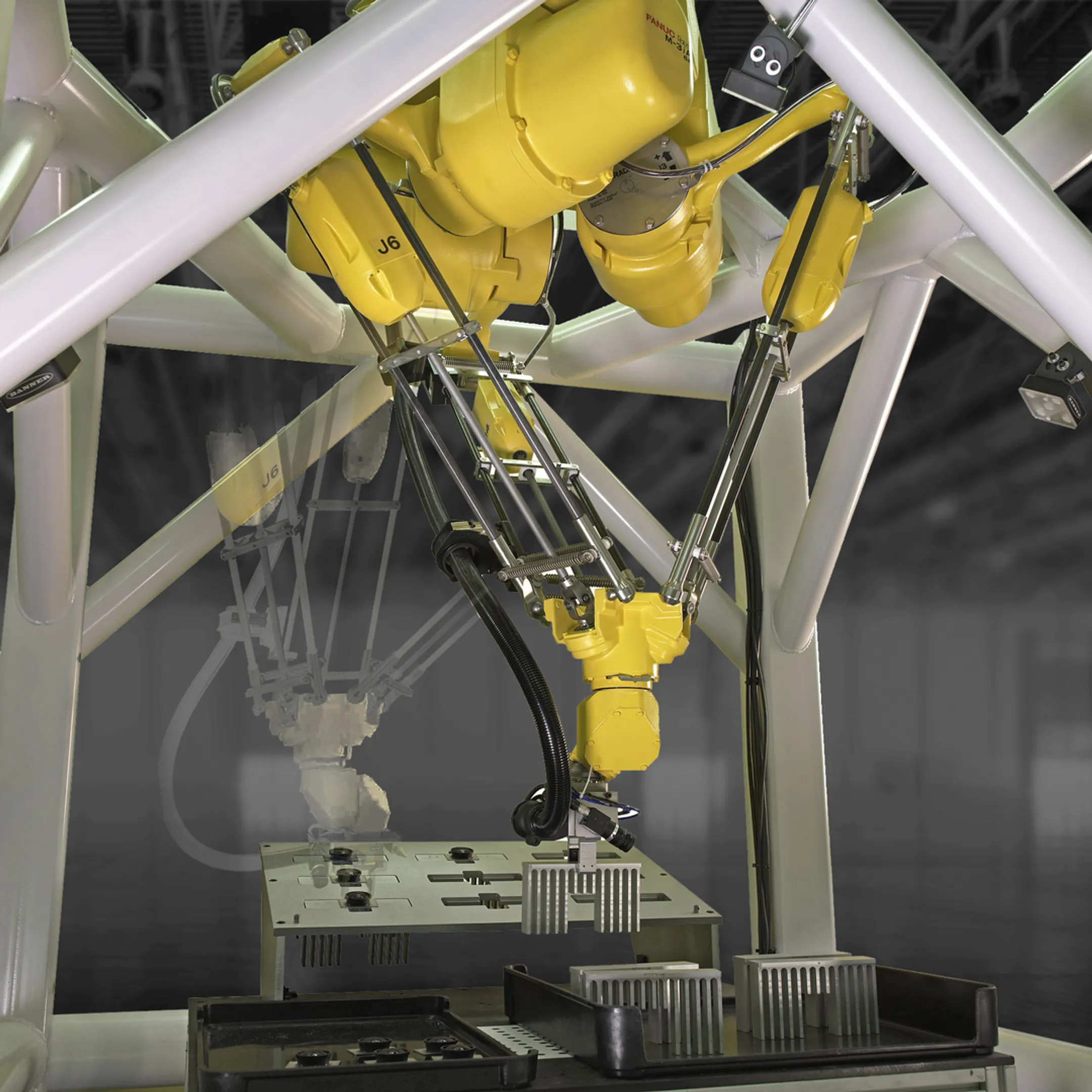 Engineers reviewing a robotic assembly cell