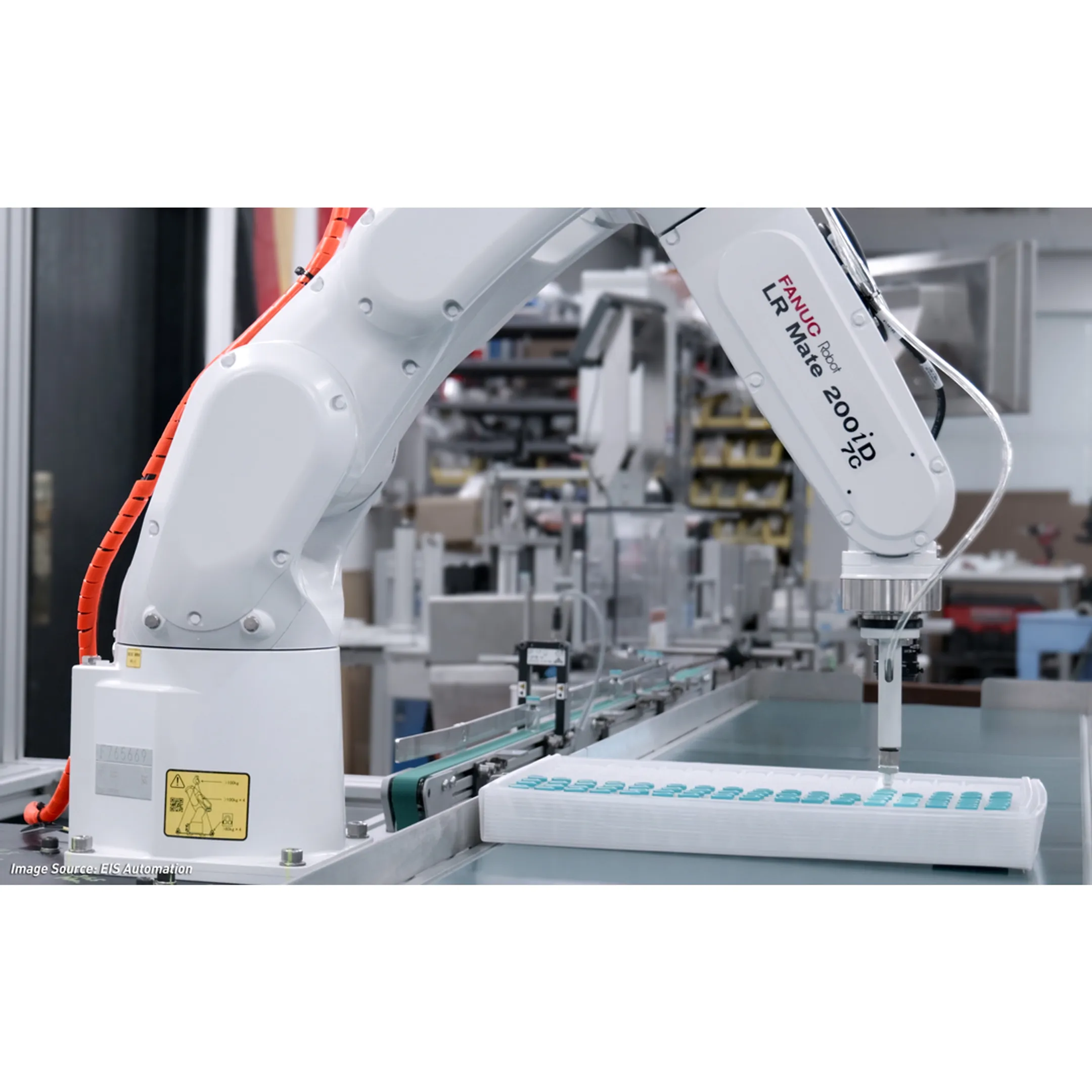 Engineers reviewing a robotic packaging cell