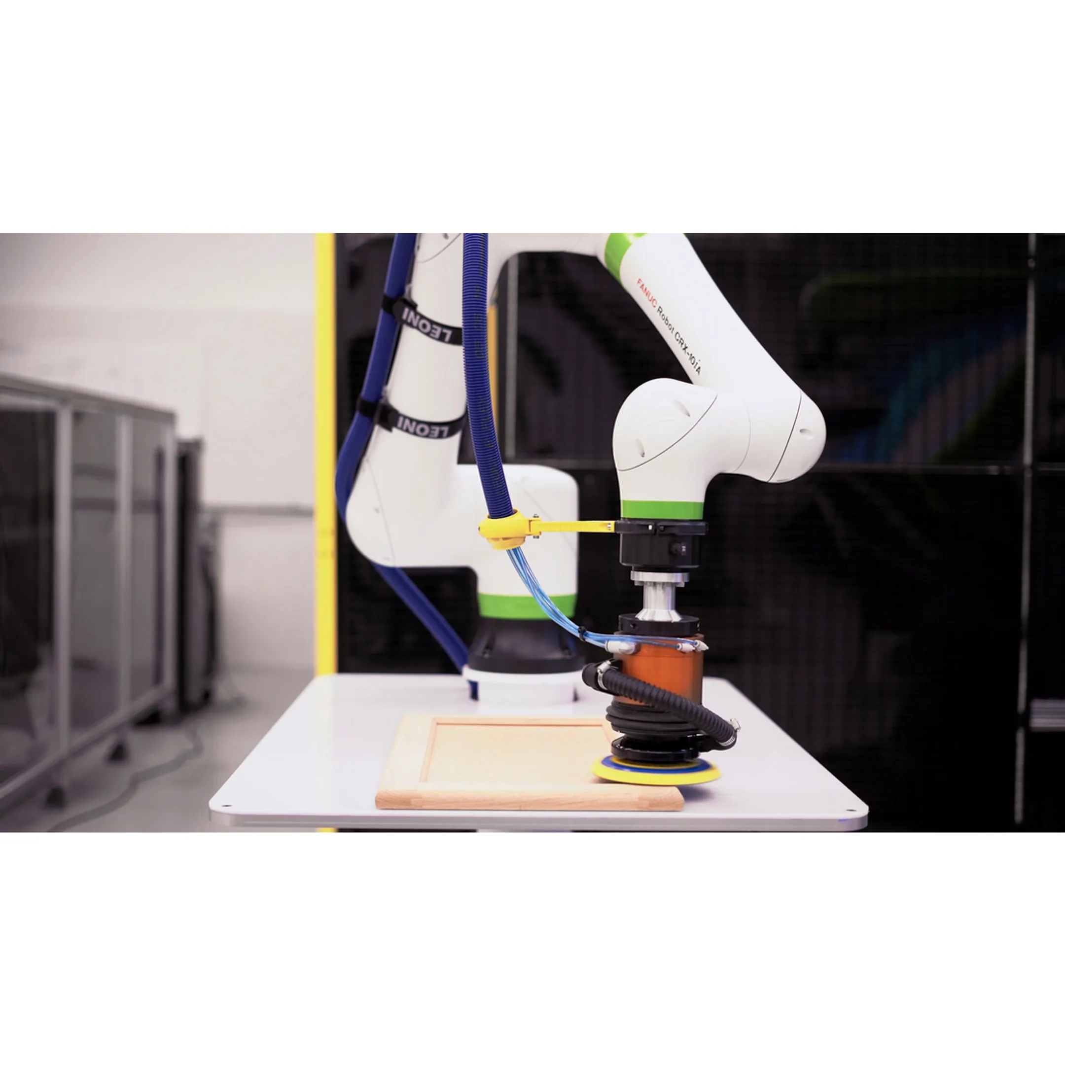 Engineer programming a robotic finishing cell
