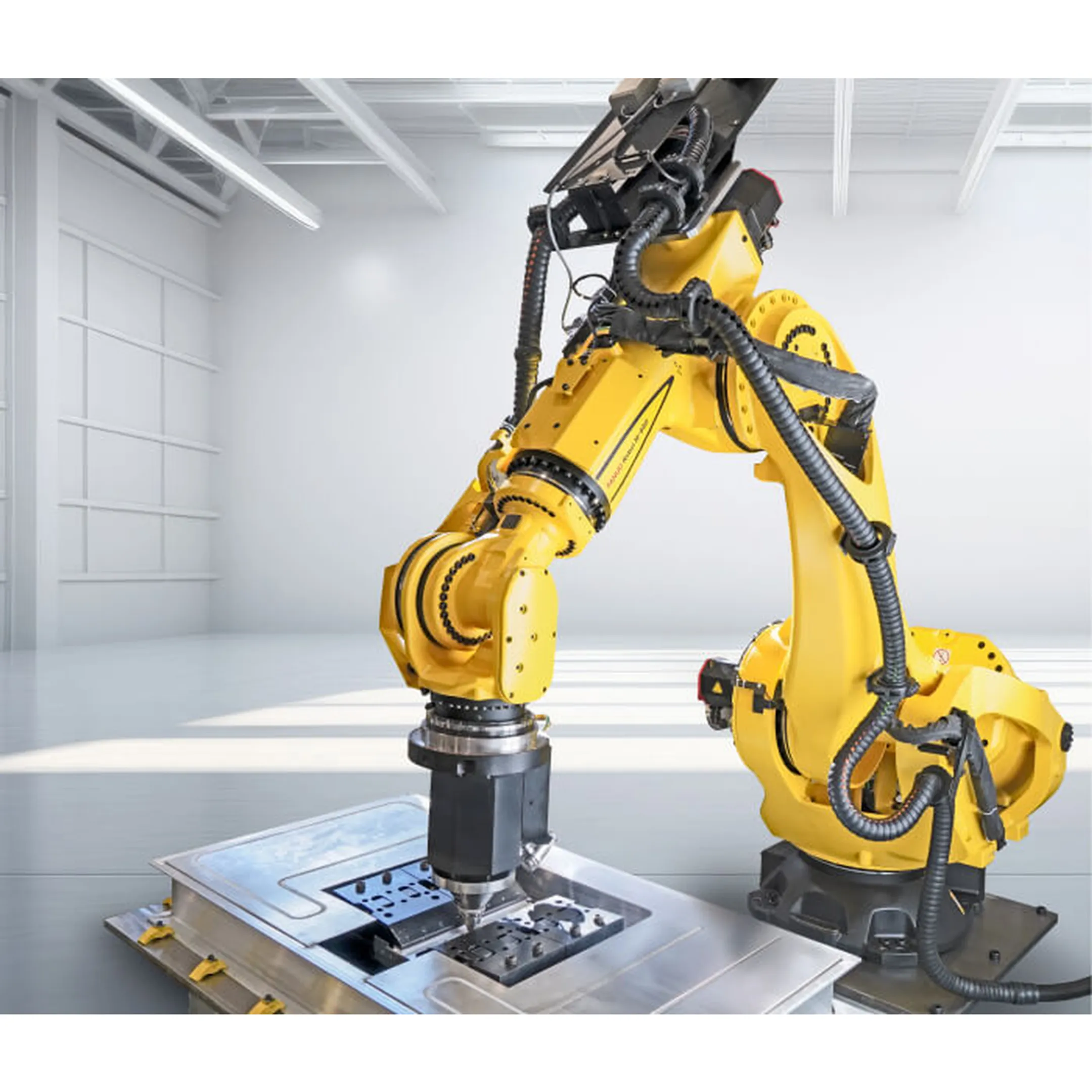 Engineer programming a robotic press tending cell
