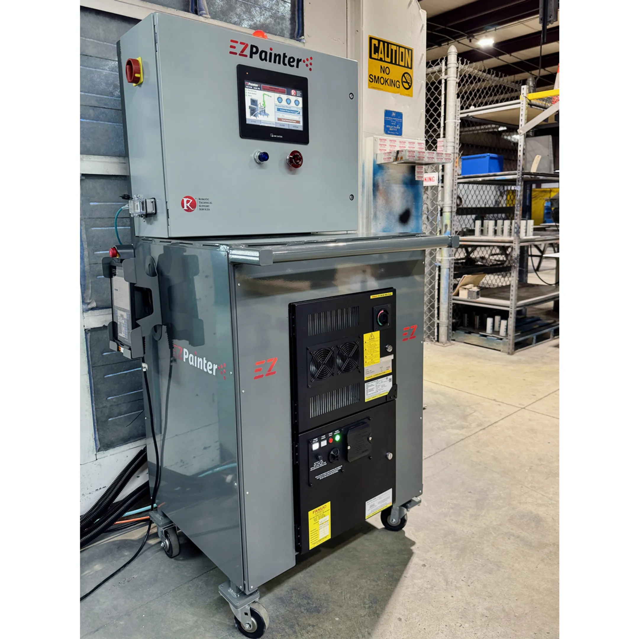 Engineer reviewing robotic dispensing cell programming