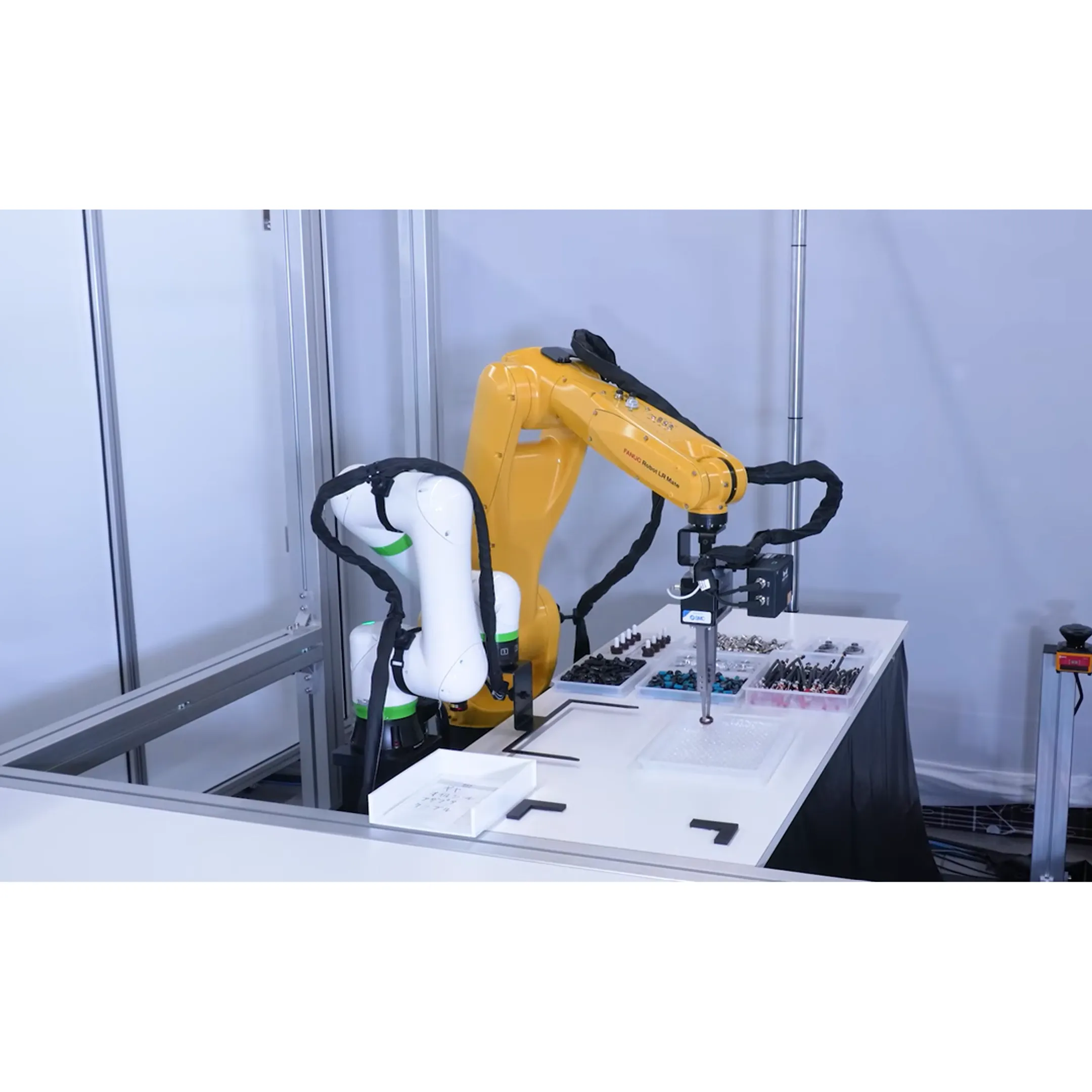 Engineers reviewing a robotic assembly cell