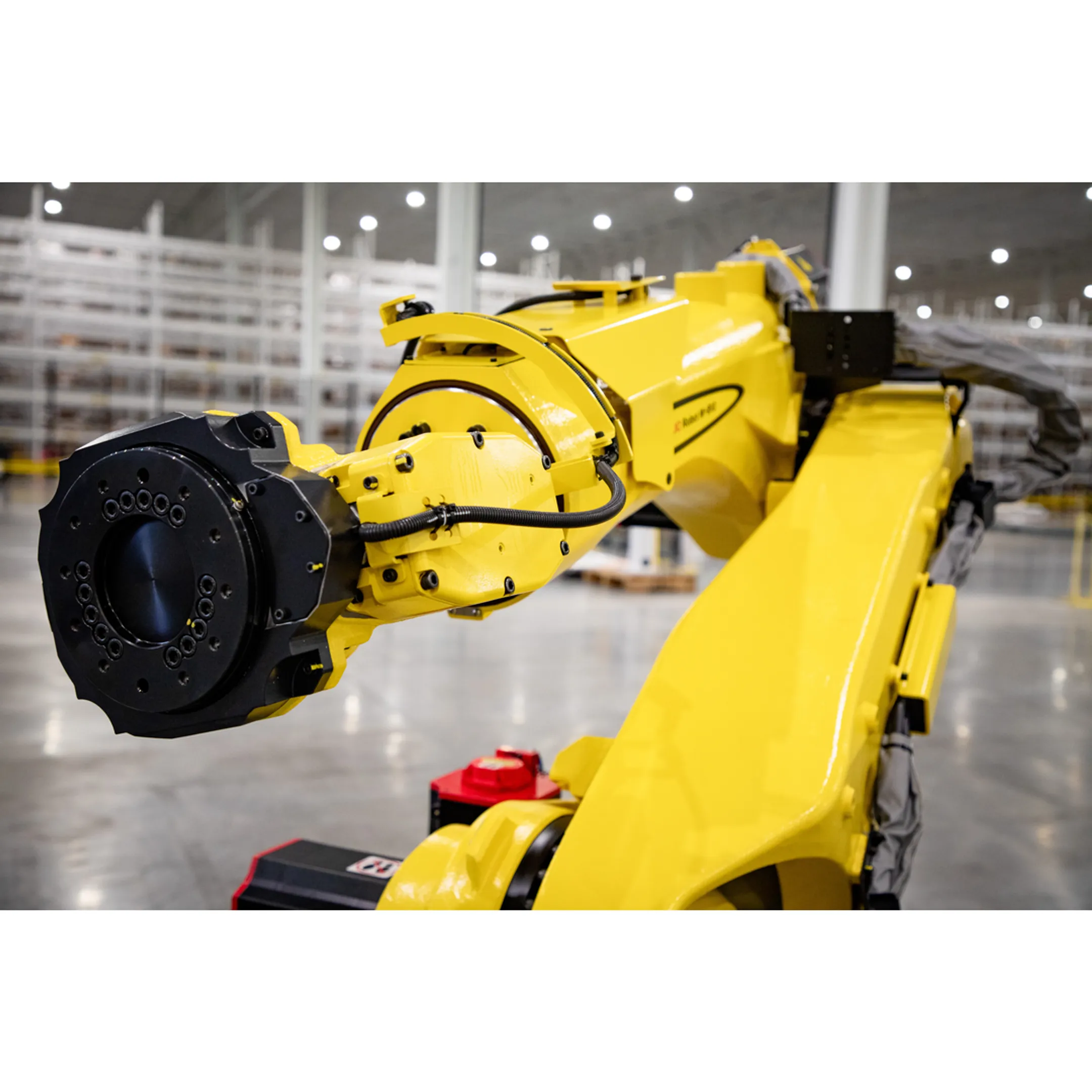 Robotic automation cell being reviewed by manufacturing engineers