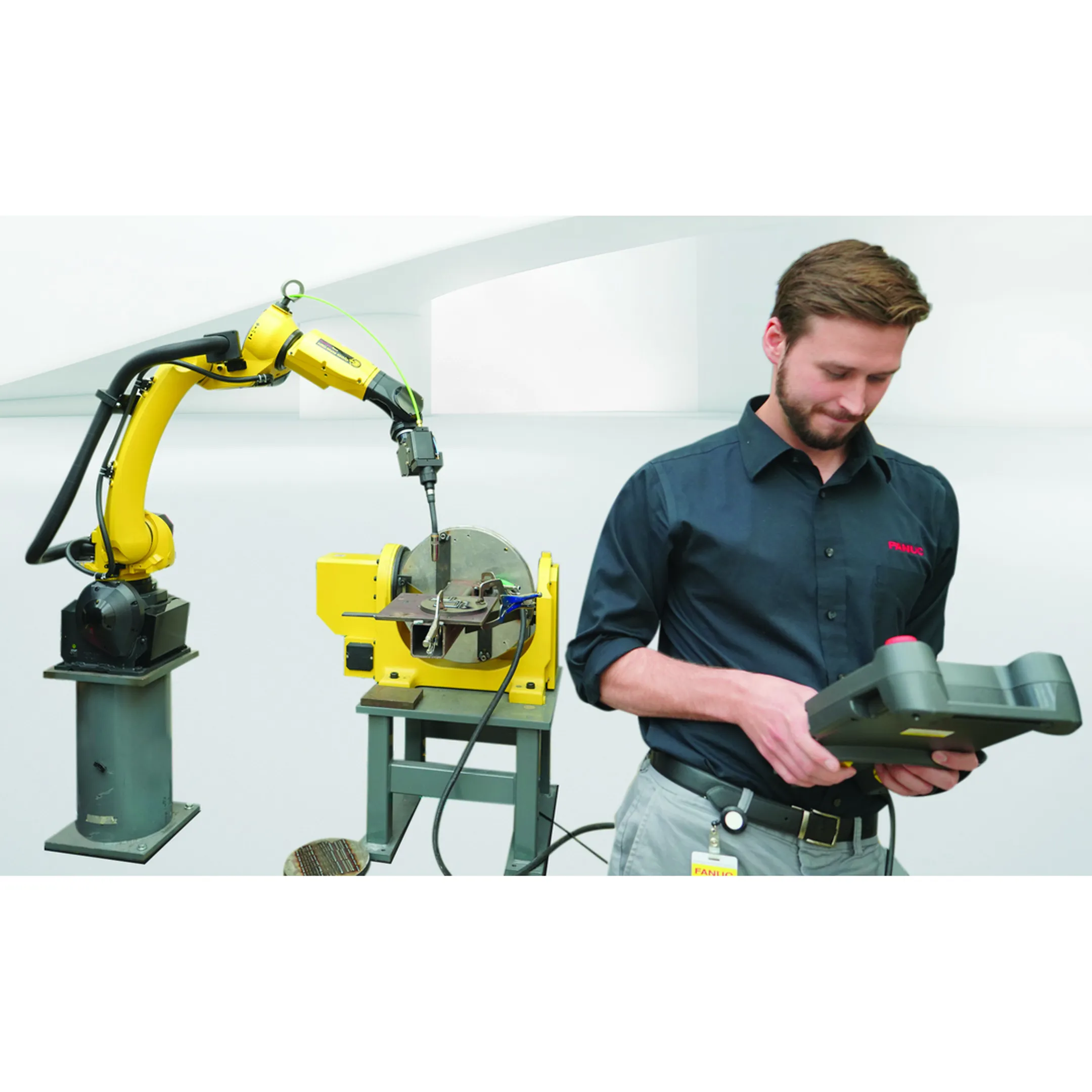 Engineer reviewing a robotic pipe welding cell