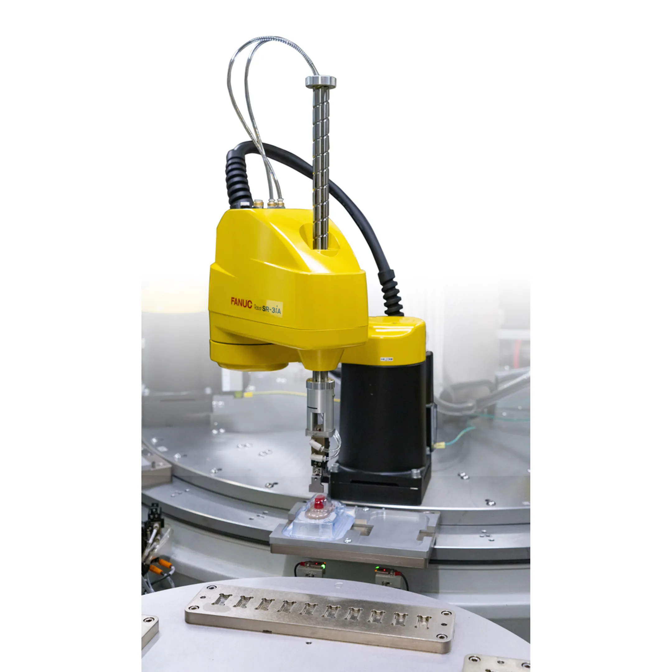 Engineer reviewing a robotic extrusion automation cell