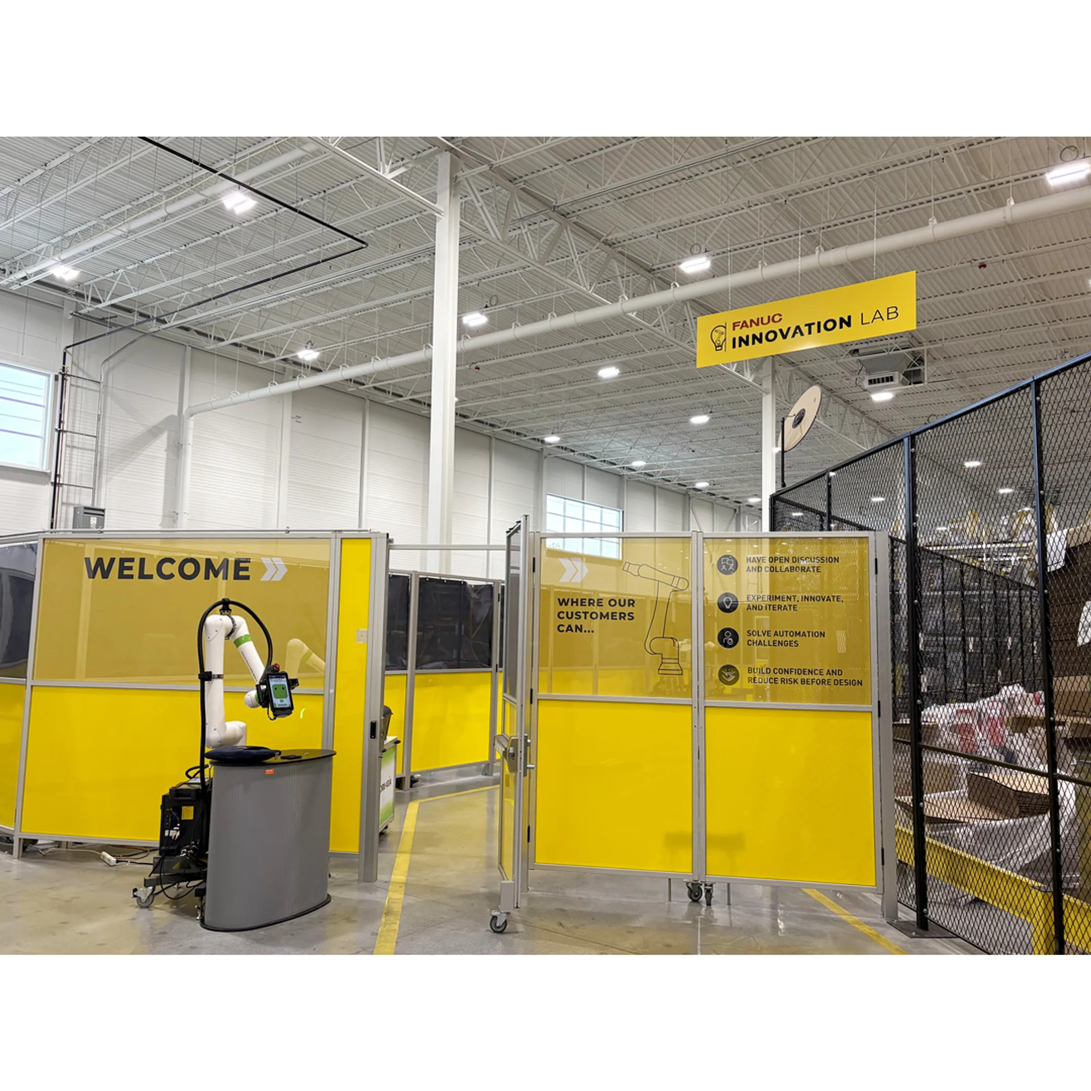 Robotic automation engineer reviewing production simulation