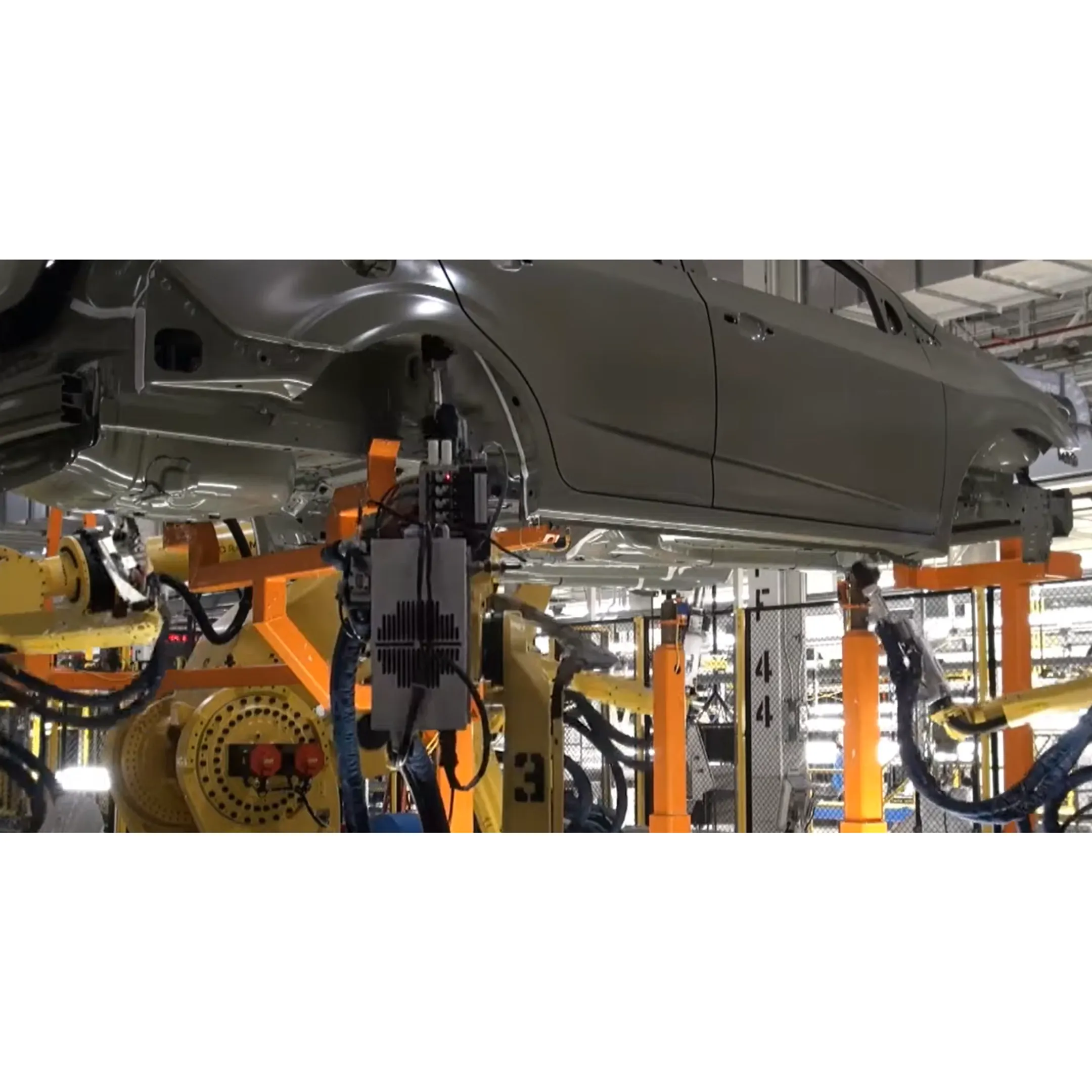 Robotic adhesive dispensing system applying a precise bead to an automotive component