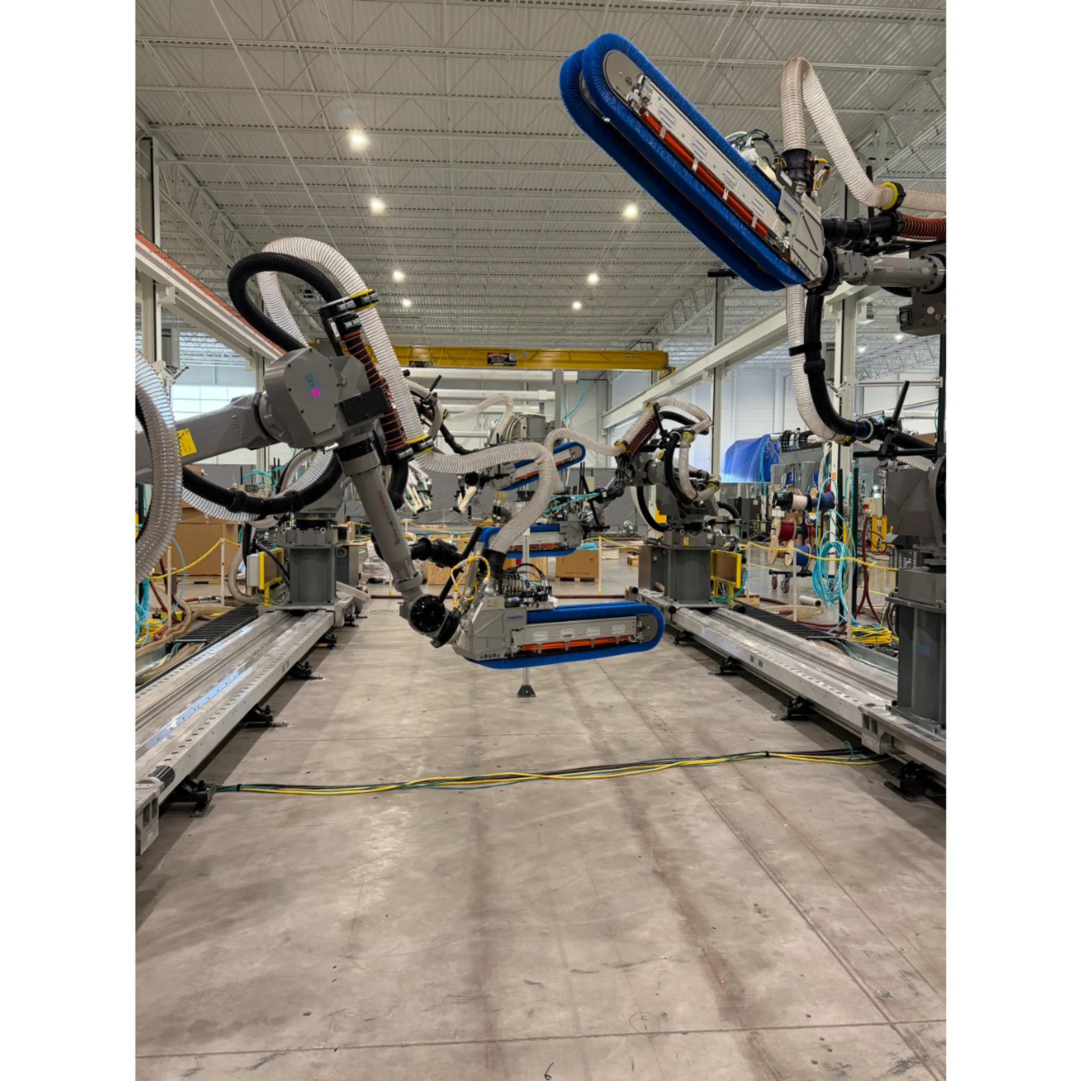 Robotic paint system applying an even coating to a heavy equipment component