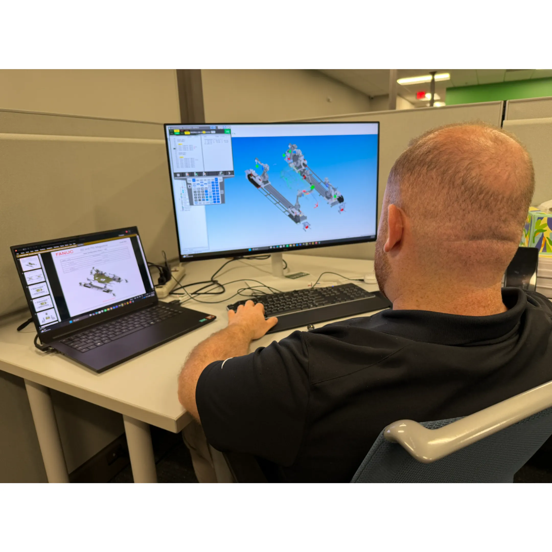 Automation engineer reviewing FANUC robot diagnostics