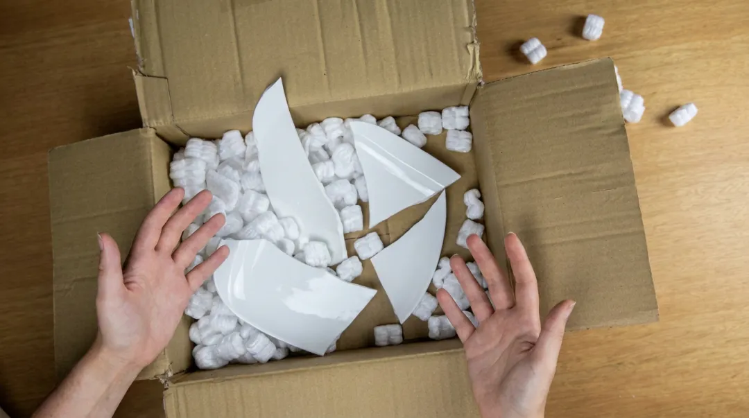 Damaged product inside packaging showing failed insert protection during shipping transit