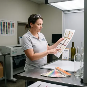 Designer reviewing custom wine label proofs