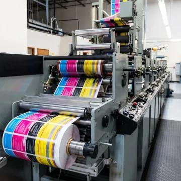 Colorful custom product labels being produced on industrial printing equipment