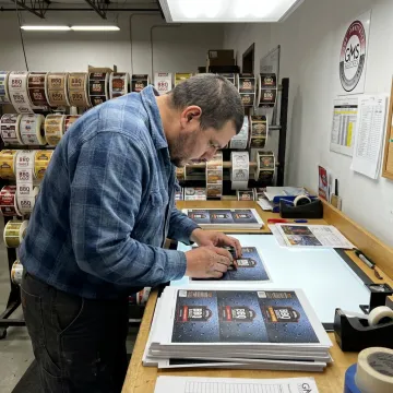 Technician reviewing custom sauce label proofs