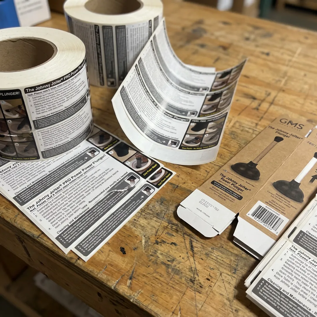 Safety labels and instruction inserts on production table
