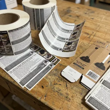 Safety labels and instruction inserts on production table