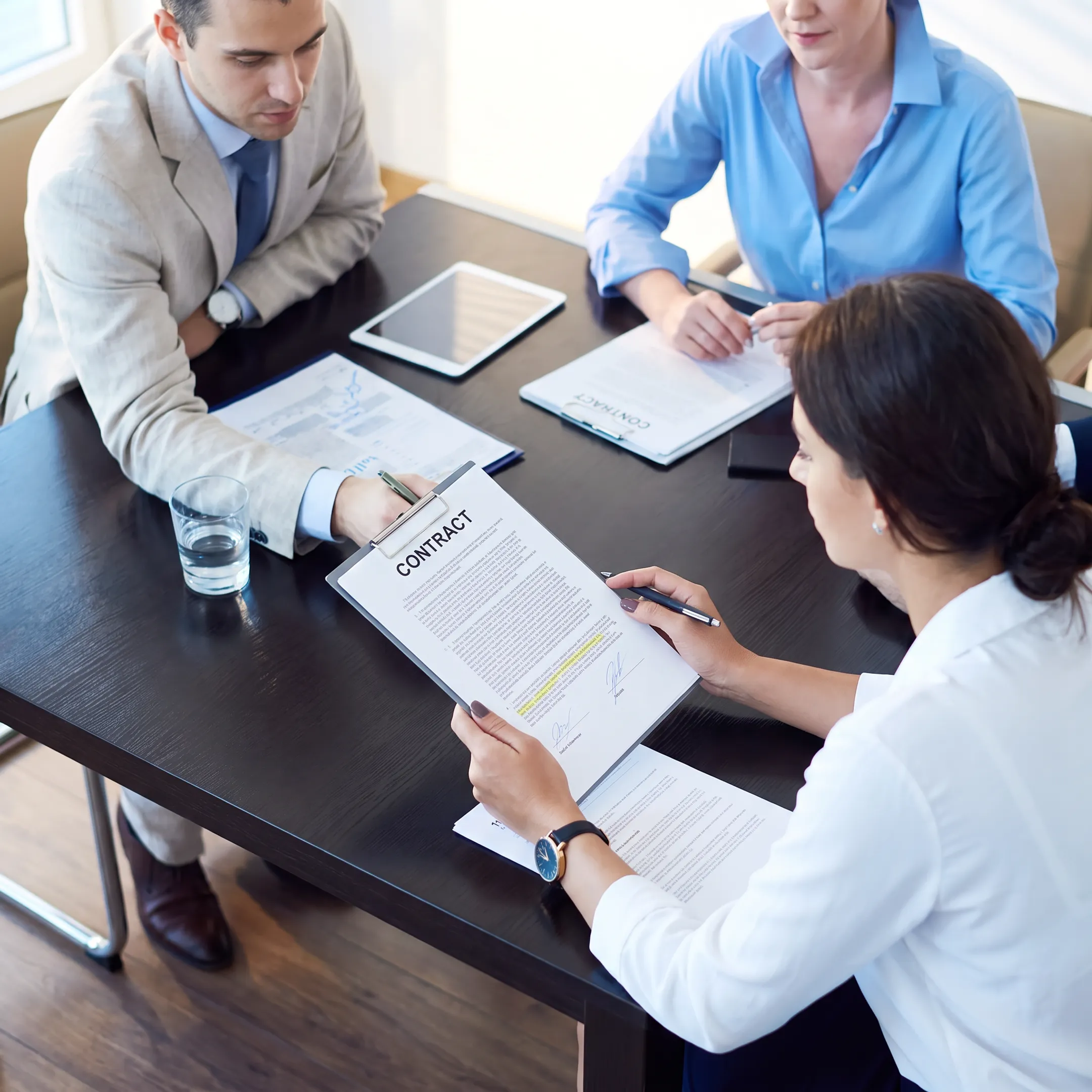 Attorney reviewing a business contract with a client in a Florida law office