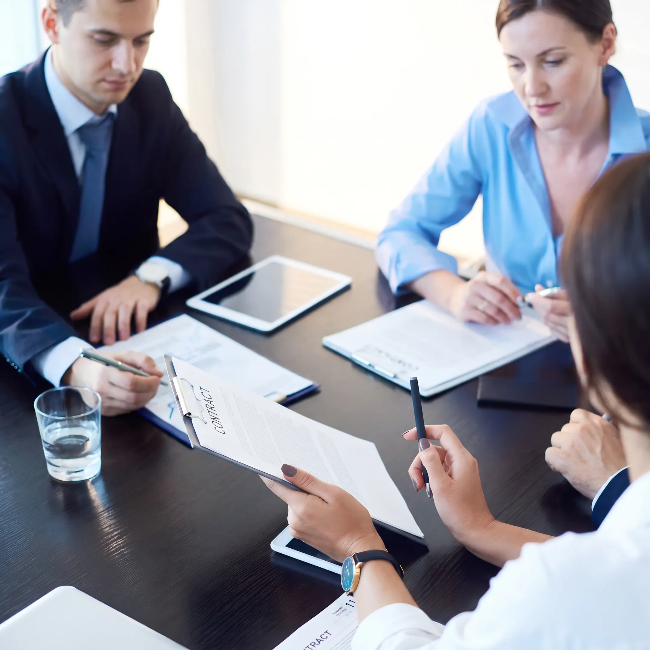 Business attorneys discussing an acquisition strategy with company representatives