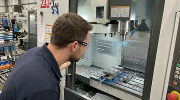 Technician wearing Myto AI glasses diagnosing CNC machine spindle vibration